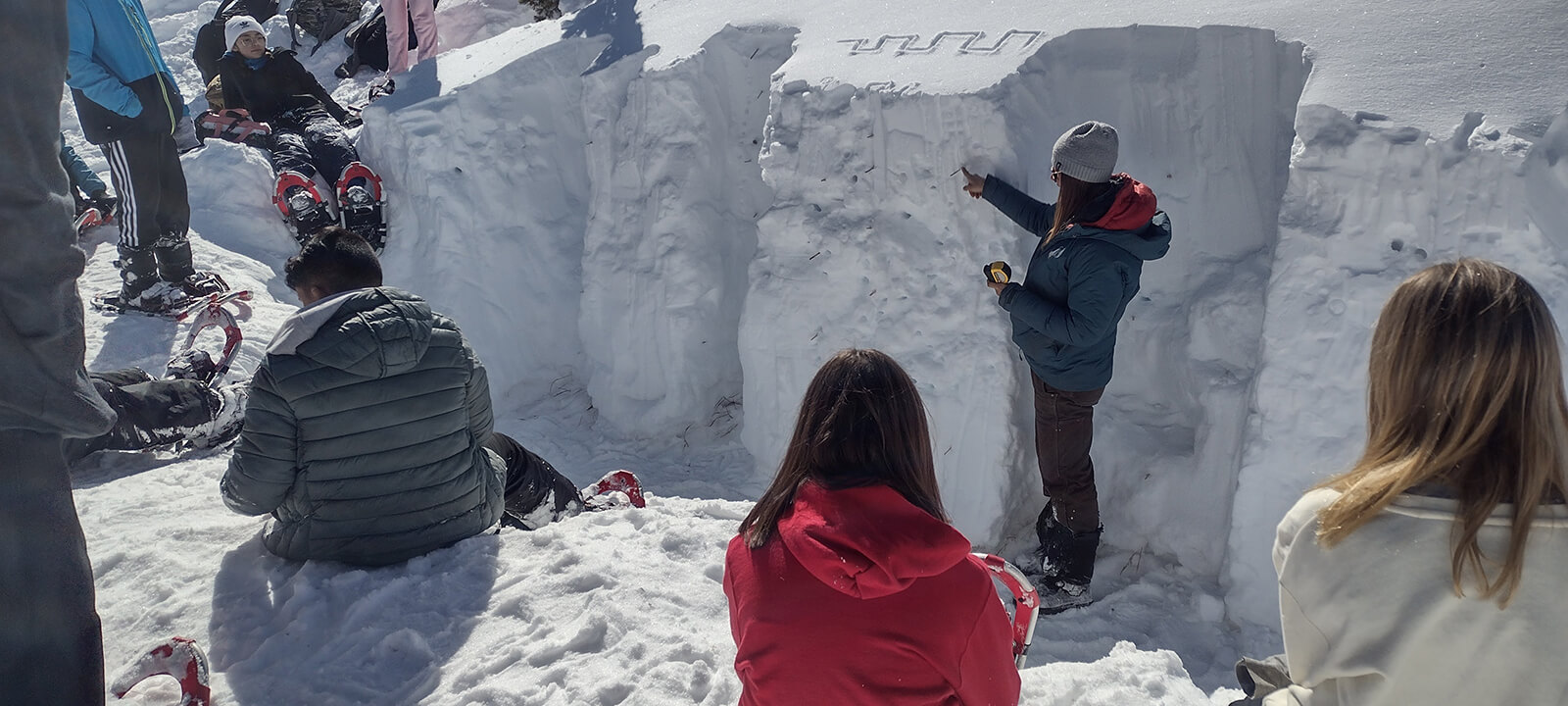 Students study the snow as part of a science lesson at Mountain Middle School.