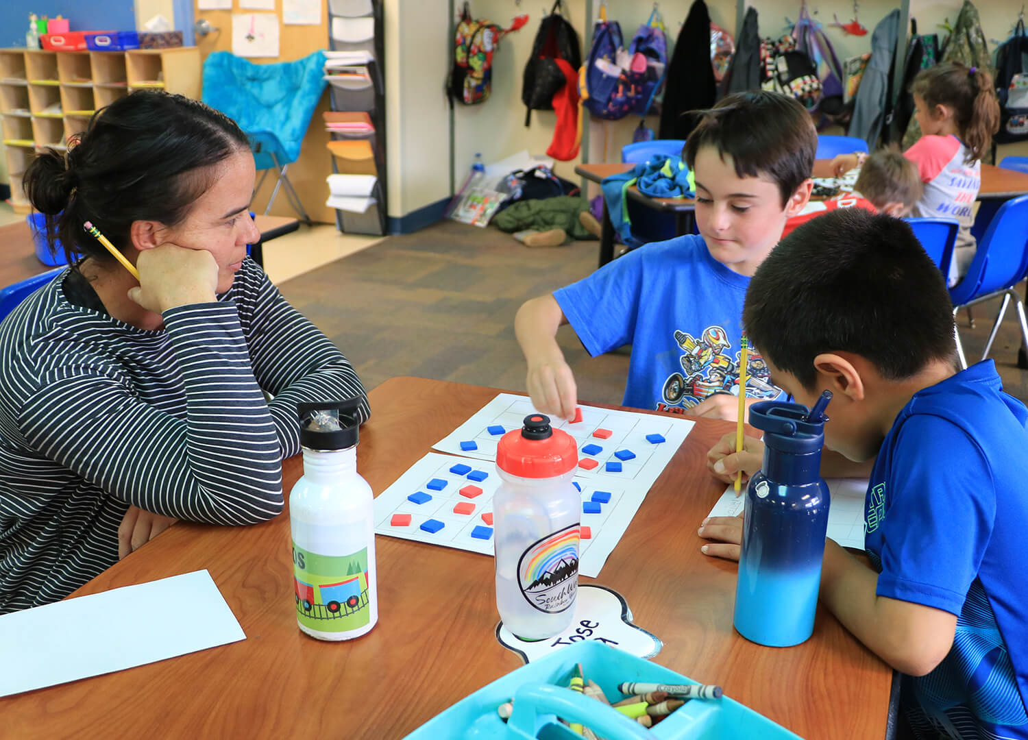 Teacher interacts with 1st grade student